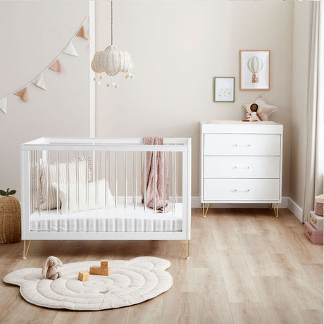 Babymore Kimi Acrylic 2-Piece Room Set in a beige nursery with pink accents