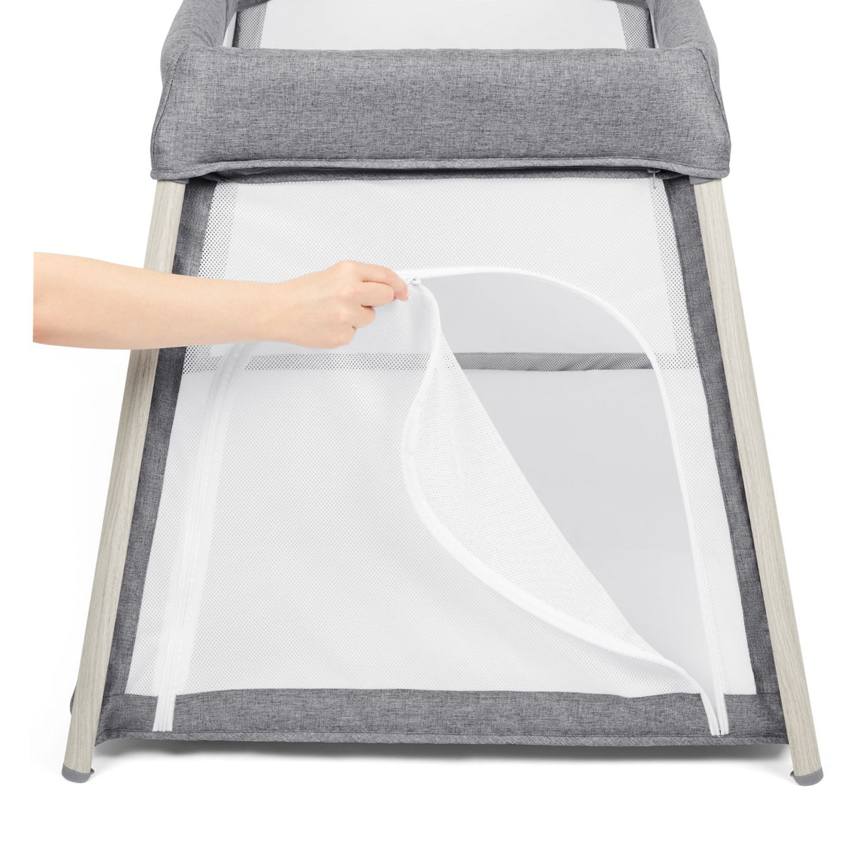 Person opening the zip door at the side of Ickle Bubba Scout 2-in-1 Travel Cot and Playpen