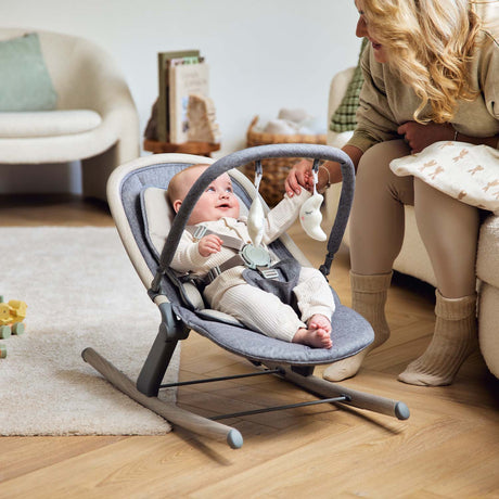 Mom looking at her smiling baby sitting in Ickle Bubba Stella Rocker