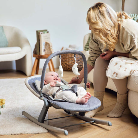 Baby lying safely in Ickle Bubba Stella Rocker in middle recline position