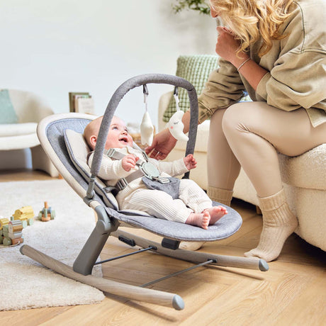 Happy baby lying down in Ickle Bubba Stella Rocker