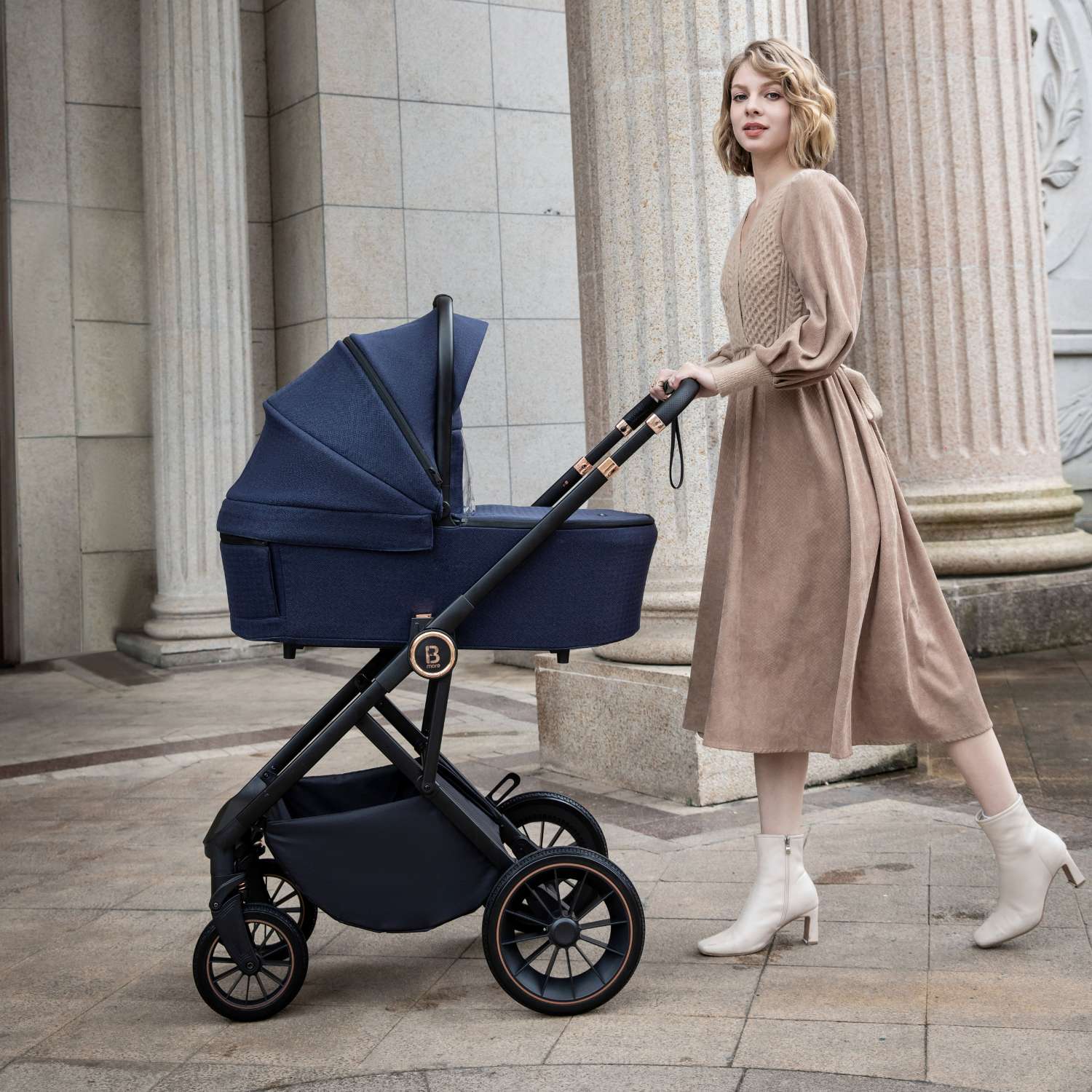 a woman with a Babymore Chia with carrycot in Midnight Blue colour