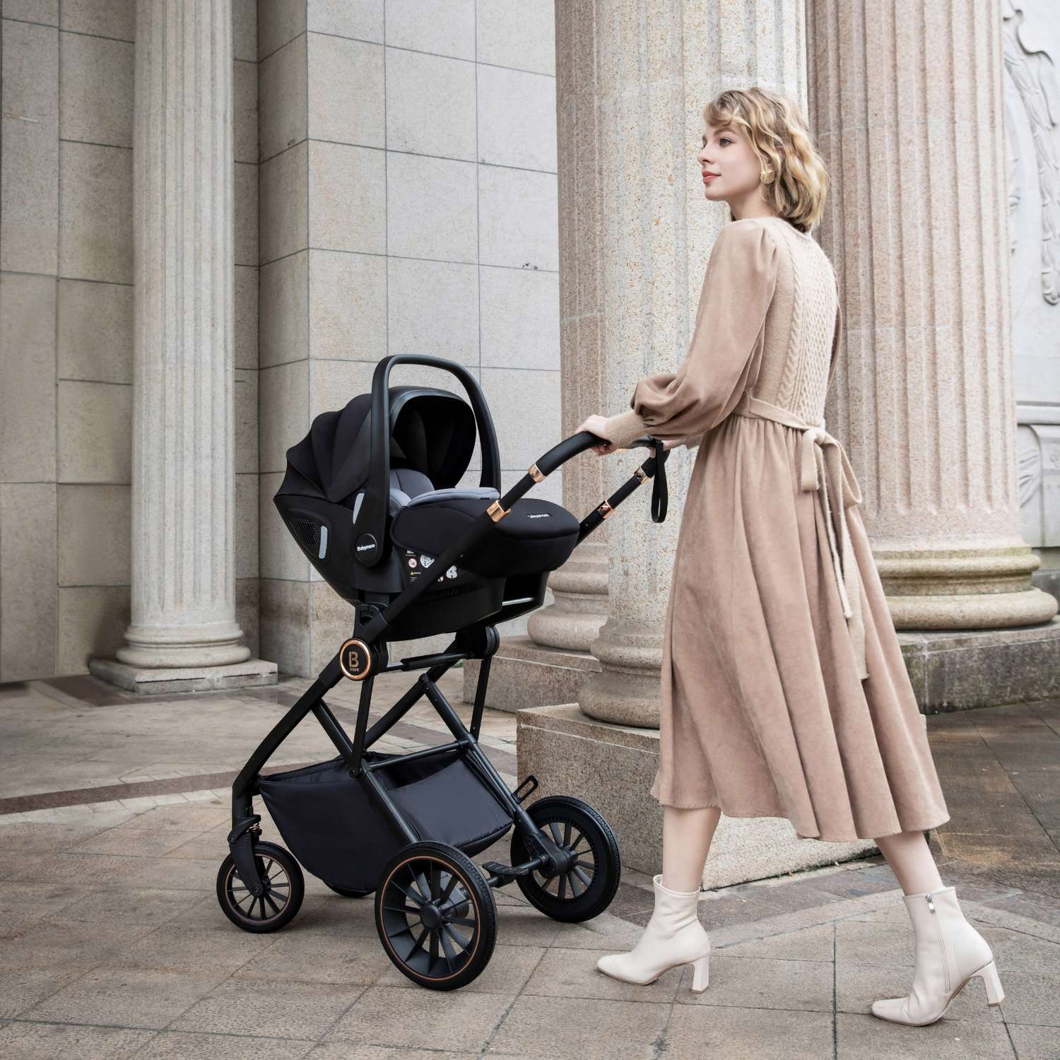 a woman with a Babymore Chia stroller with Pecan car seat attached