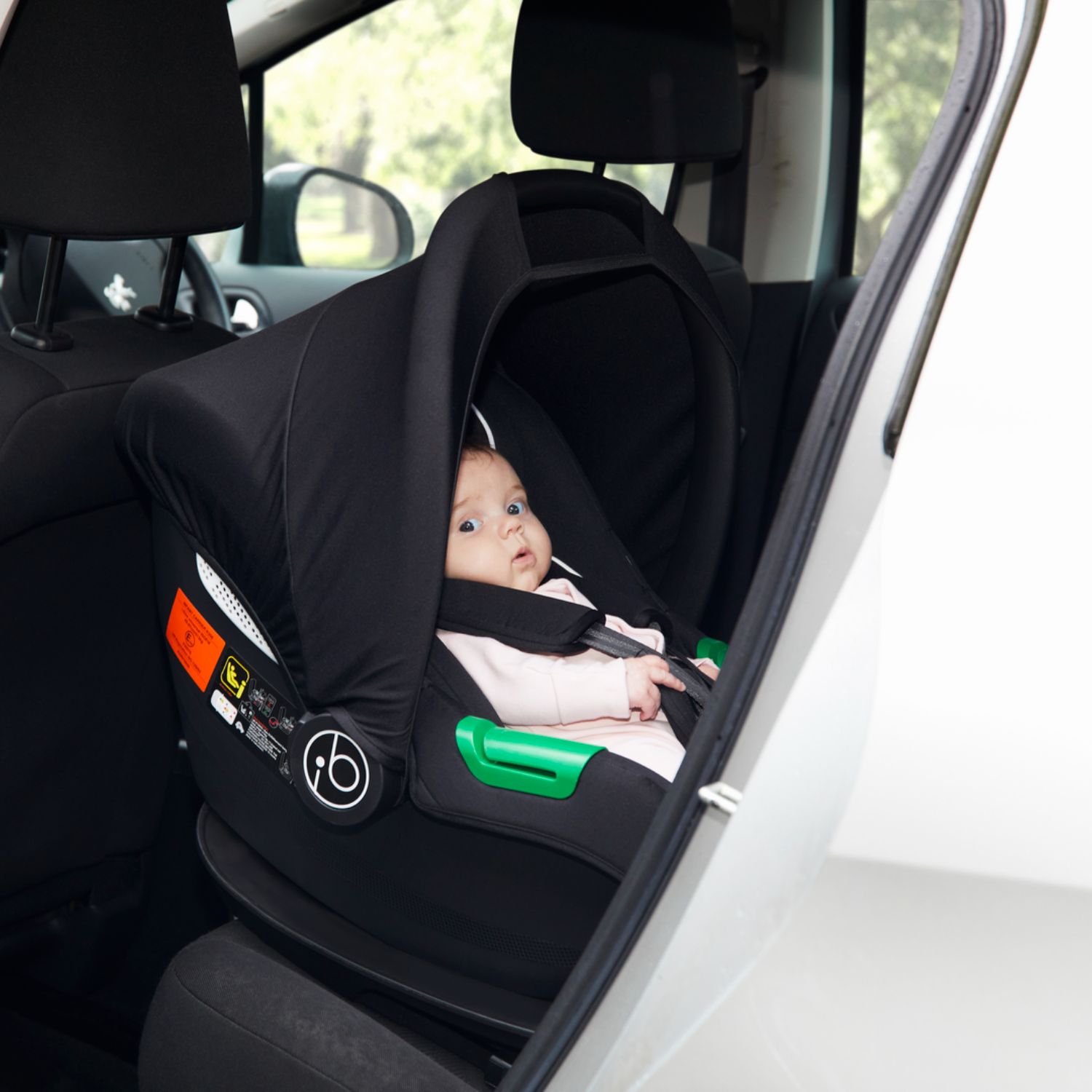 A baby in an Ickle Bubba Cirrus i-Size Car Seat