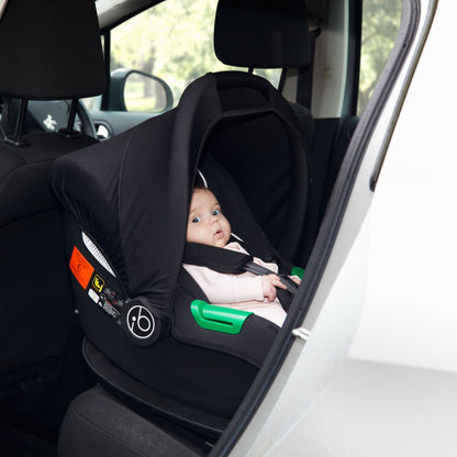 A baby looking outside while riding an Ickle Bubba Cirrus i-Size Car Seat inside a car
