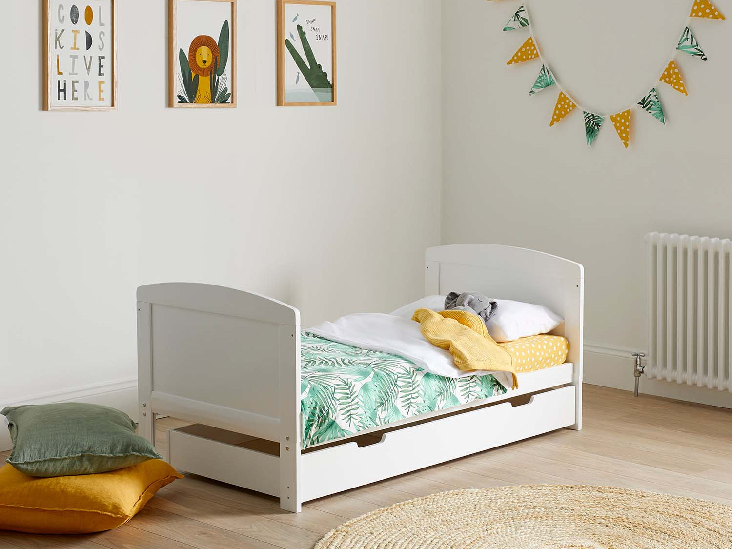 Ickle Bubba Coleby Classic Cot Bed with Under Drawer converted to toddler bed in a zoo-themed nursery room