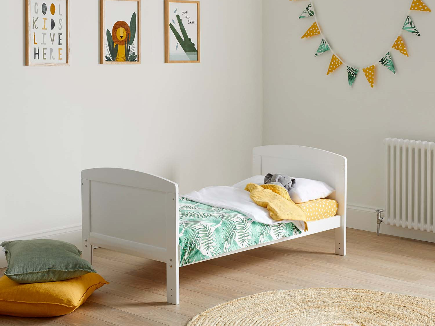 Ickle Bubba Coleby Classic Cot Bed converted to toddler bed in a zoo-themed nursery room