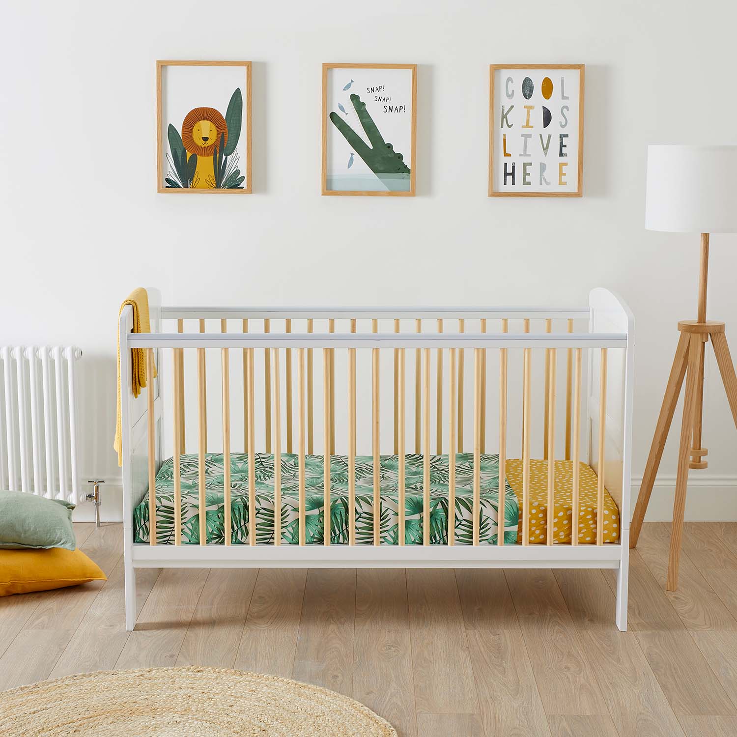 An Ickle Bubba Coleby Scandi Cot Bed in an safari-themed nursery room