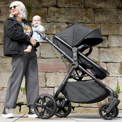 Mother and baby with an Ickle Bubba Comet 3-in-1 Travel System with Astral Car Seat in Black color
