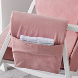 Storage pocket with linens at the side of Dursley Rocking Chair in Blush Pink colour