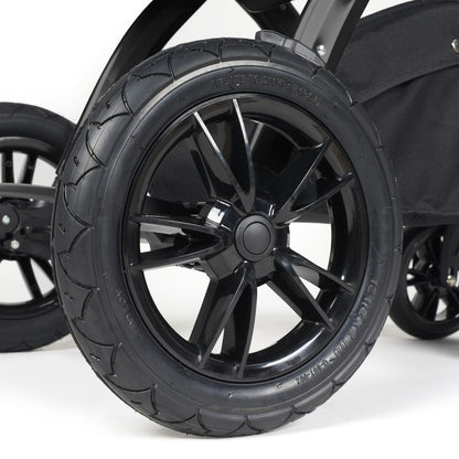 Close-up shot of all-terrain wheels in Ickle Bubba Stomp Luxe Pushchair in Woodland green colour