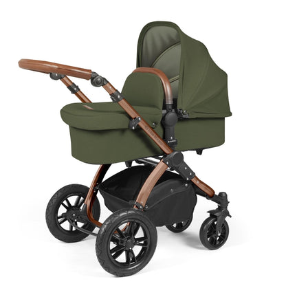 Ickle Bubba Stomp Luxe Pushchair with carrycot attached in Woodland green colour with bronze chassis and tan handle