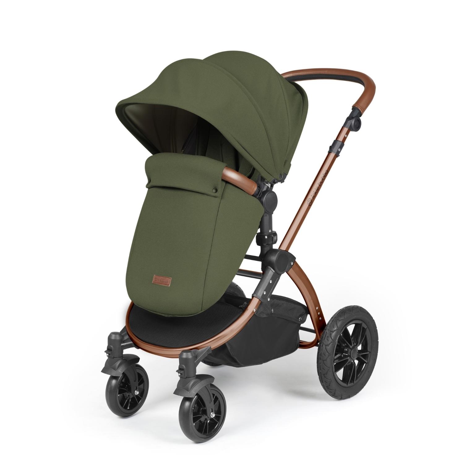 Ickle Bubba Stomp Luxe Pushchair with foot warmer attached in Woodland green colour with bronze chassis and tan handle