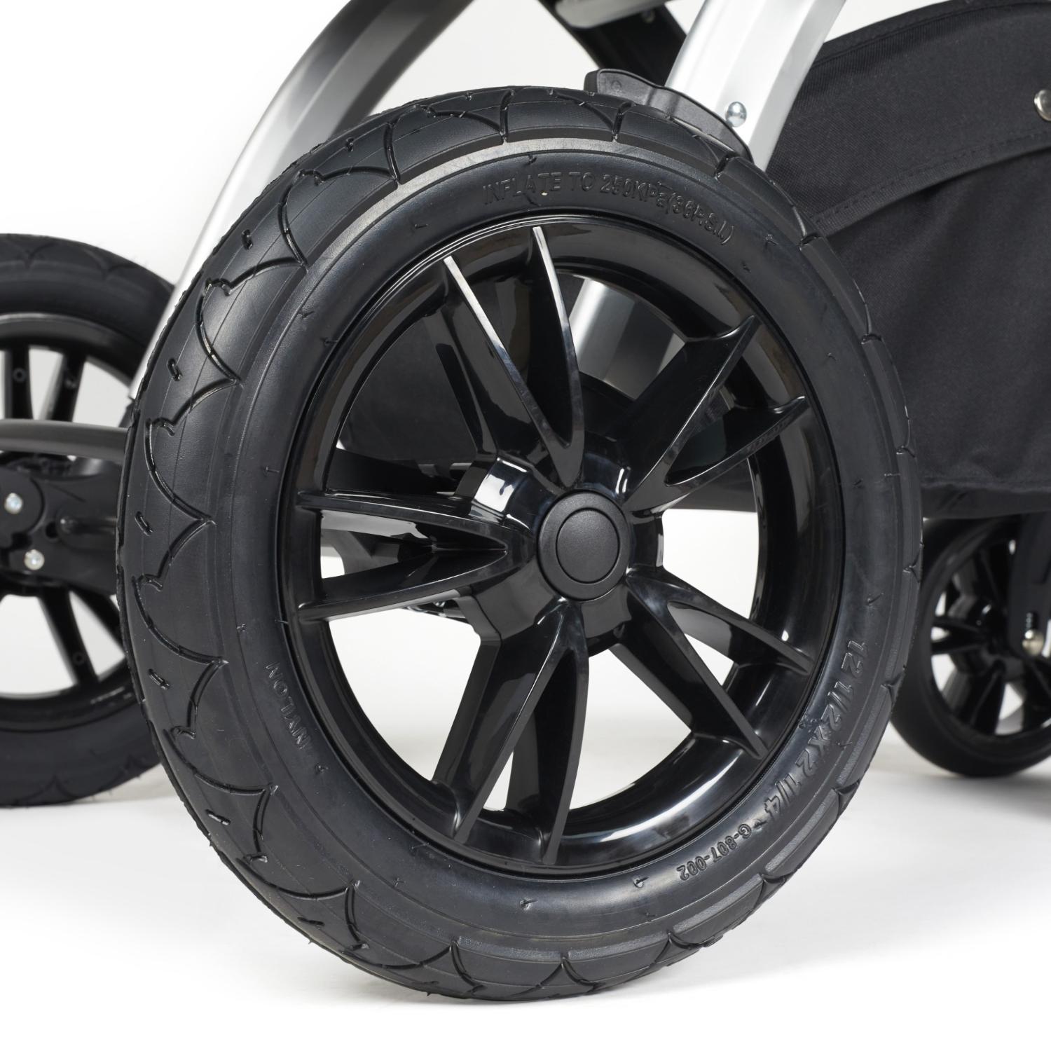 Close-up shot of all-terrain wheels in Ickle Bubba Stomp Luxe Pushchair in Charcoal Grey colour with silver chassis and tan handle