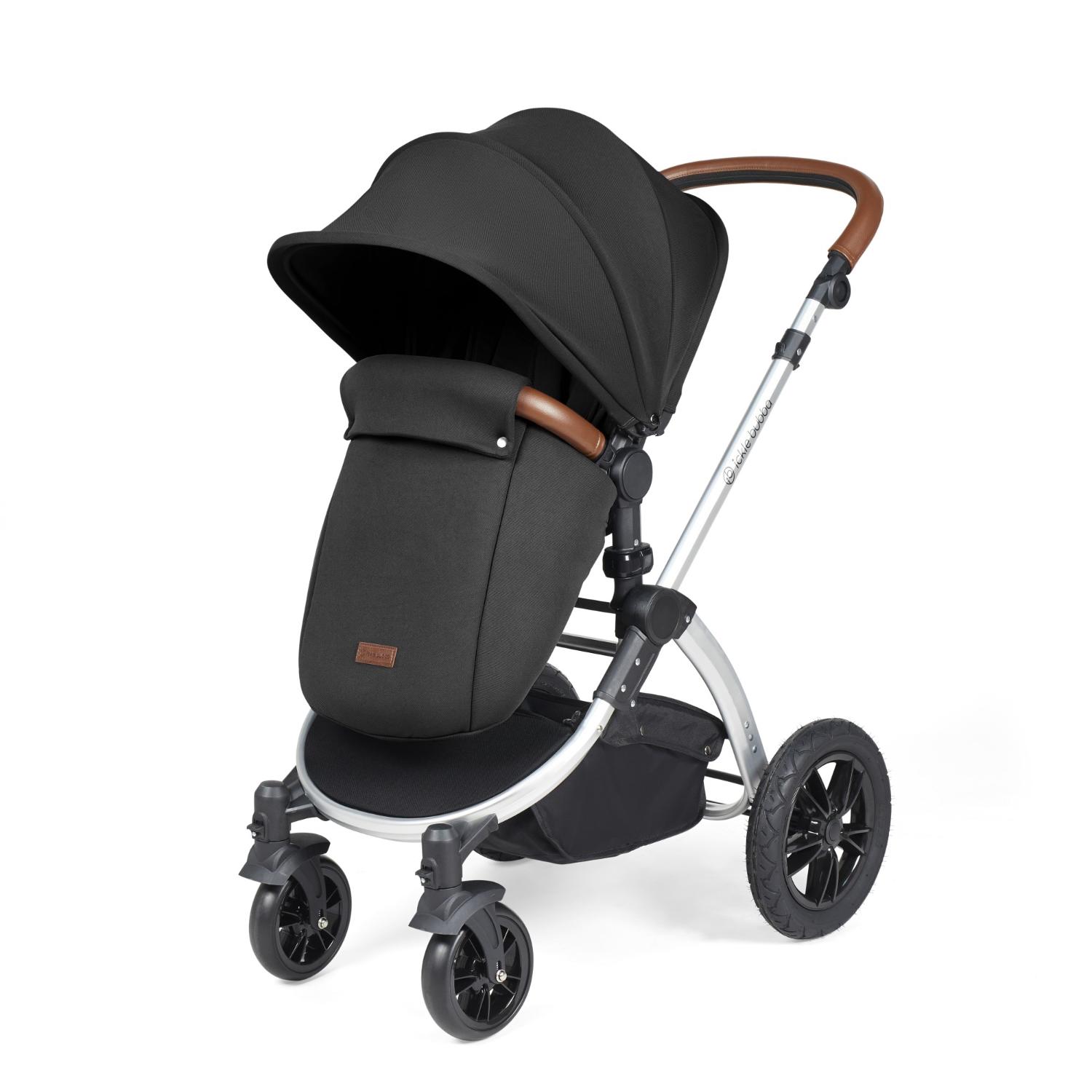 Ickle Bubba Stomp Luxe Pushchair with foot warmer attached in Midnight black colour with silver chassis and tan handle