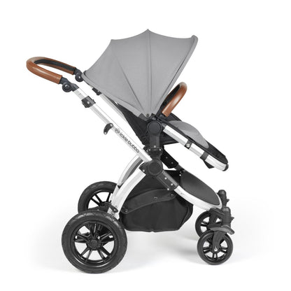 Side view of Ickle Bubba Stomp Luxe Pushchair with seat unit attached in Pearl Grey colour with silver chassis and tan handle