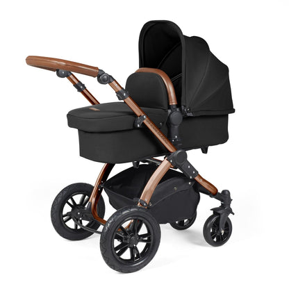 Ickle Bubba Stomp Luxe Pushchair with carrycot attached in Midnight black colour with bronze chassis and tan handle