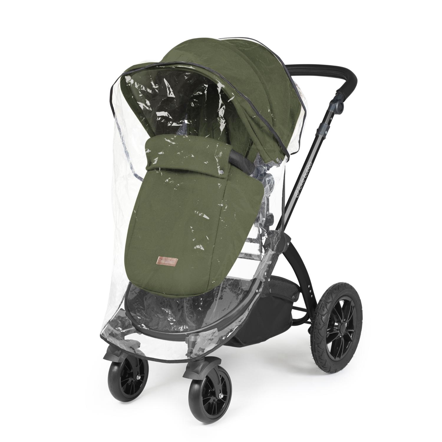 Rain cover placed on an Ickle Bubba Stomp Luxe Pushchair in Woodland green colour with bronze chassis and tan handle