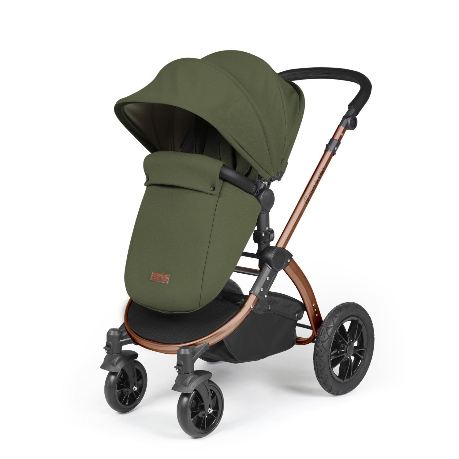 Ickle Bubba Stomp Luxe Pushchair with foot warmer attached in Woodland green colour with bronze chassis