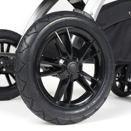 Close-up shot of all-terrain wheels in Ickle Bubba Stomp Luxe Pushchair in Charcoal Grey colour with silver chassis
