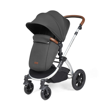 Ickle Bubba Stomp Luxe Pushchair with foot warmer attached in Charcoal Grey colour with silver chassis and tan handle