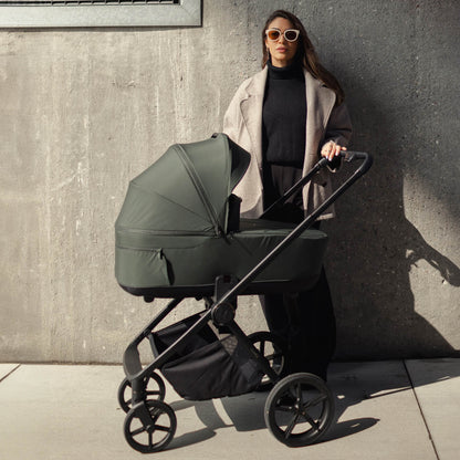 Woman with a Venicci Claro 2-in-1 Pram in Forest green colour