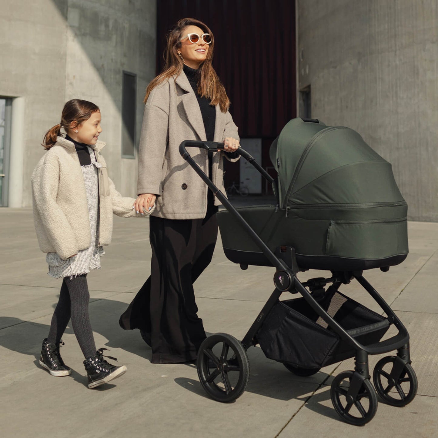 Woman and a child with a Venicci Claro 2-in-1 Pram in Forest green colour