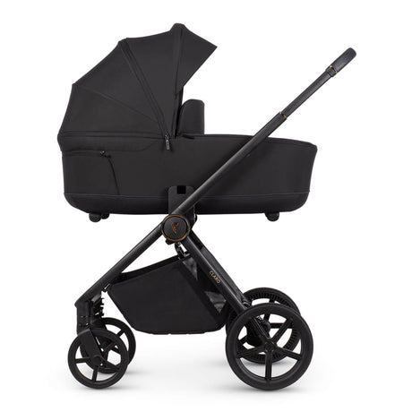 Venicci Claro carrycot in Noir black colour placed in the Claro frame