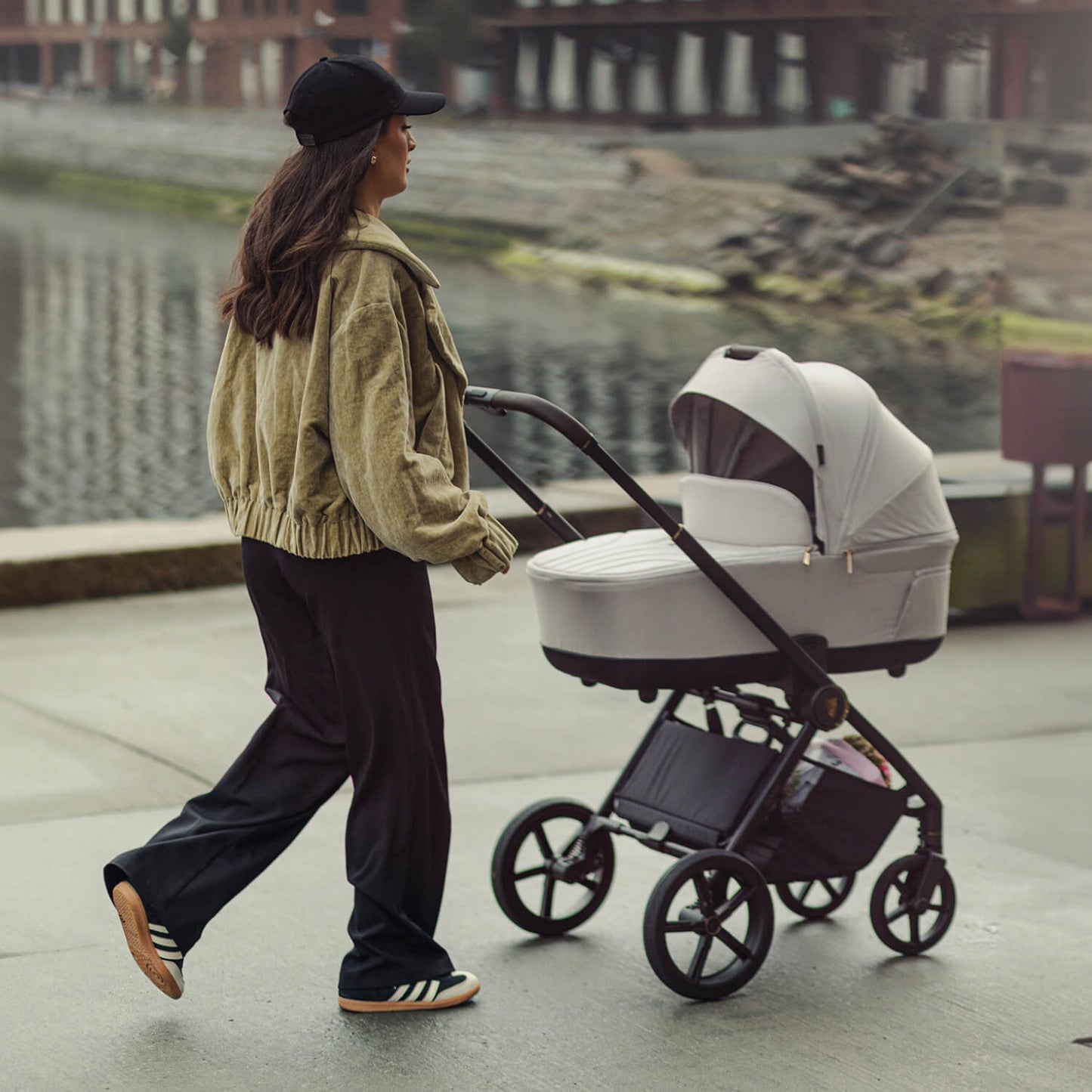 Woman walking with a Venicci Claro Pram in Vanilla white colour