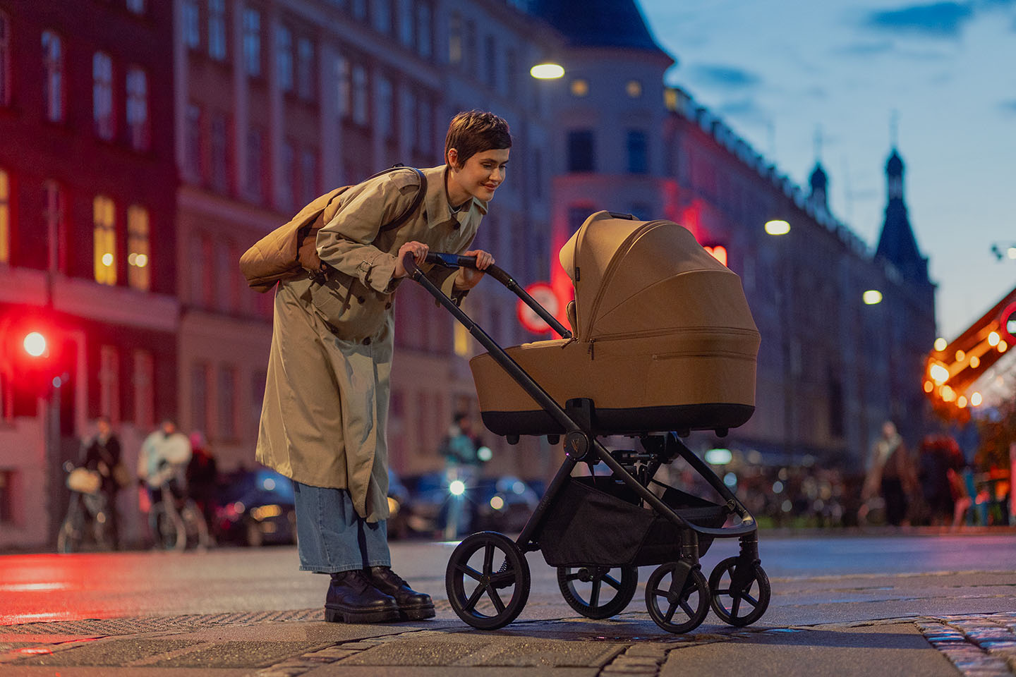A mother and a baby in Venicci Claro pram pushchair during nighttime