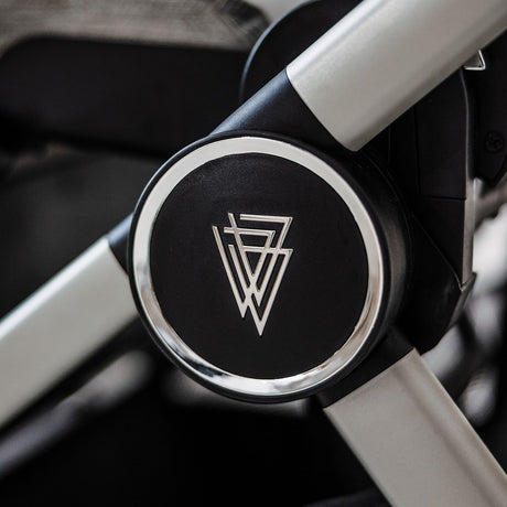 Close-up shot of logo in frame of Venicci Upline Pram in Moonstone colour